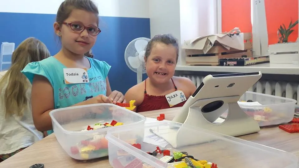 Obraz przedstawia naszych wychowanków podczas warsztatów z robotyki. Na zdjęciu możemy ujrzeć budowę robota oraz tablet dzięki któremu możemy zaprogramować robota.